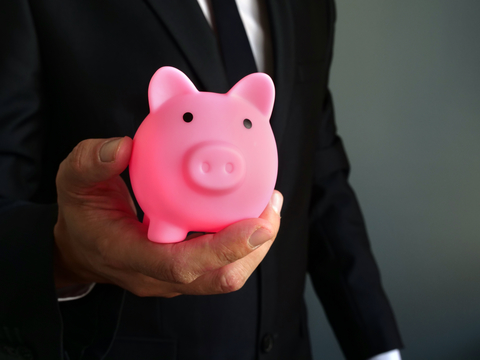 Businessman holding piggy bank